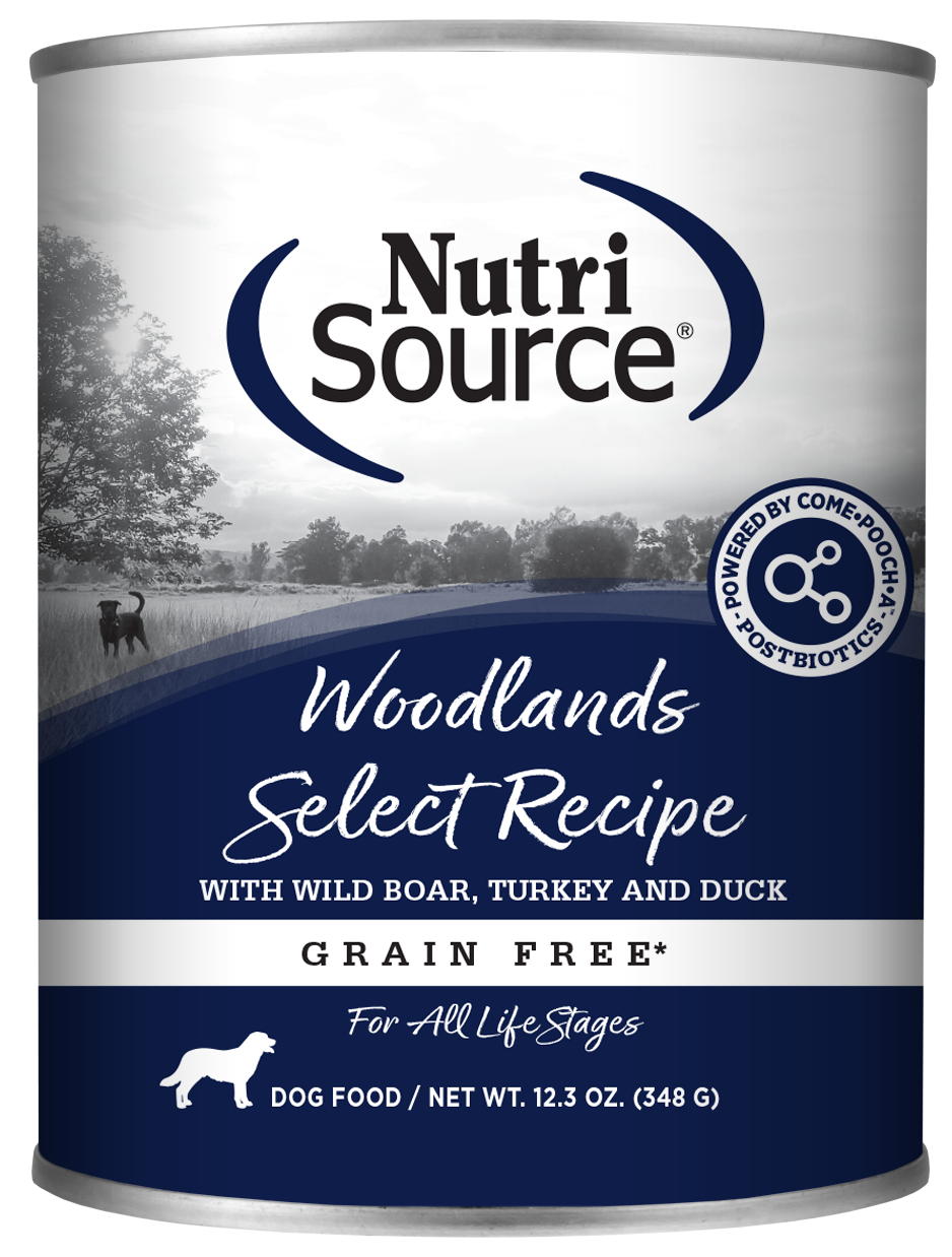 A can of NutriSource Woodlands Select Recipe dog food with wild boar, turkey, and duck. The can has a blue and white color scheme with an image of a dog and a forest in the background.