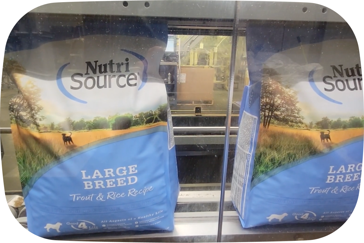 Two packages of NutriSource® large breed dog food in a manufacturing environment