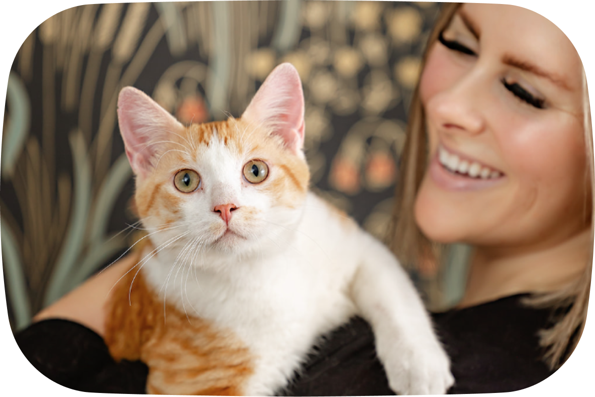 Woman holding a cat with a blurred background